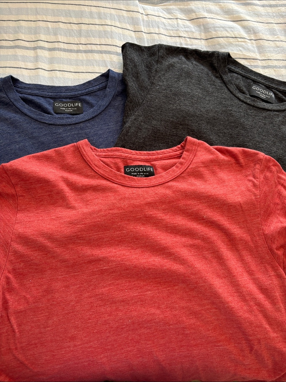 Goodlife Crew Neck Tees in Heather’d Red, Navy, and Black.
